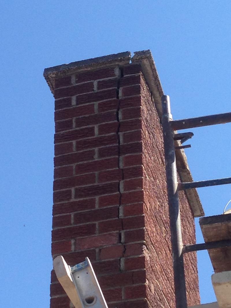 Severe mortar erosion and structural leaning identified during a routine inspection.