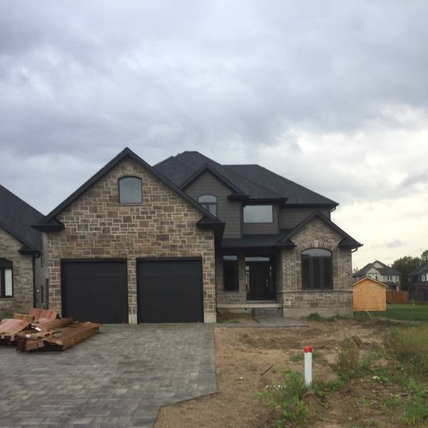 New house construction showcasing stone and brick exterior